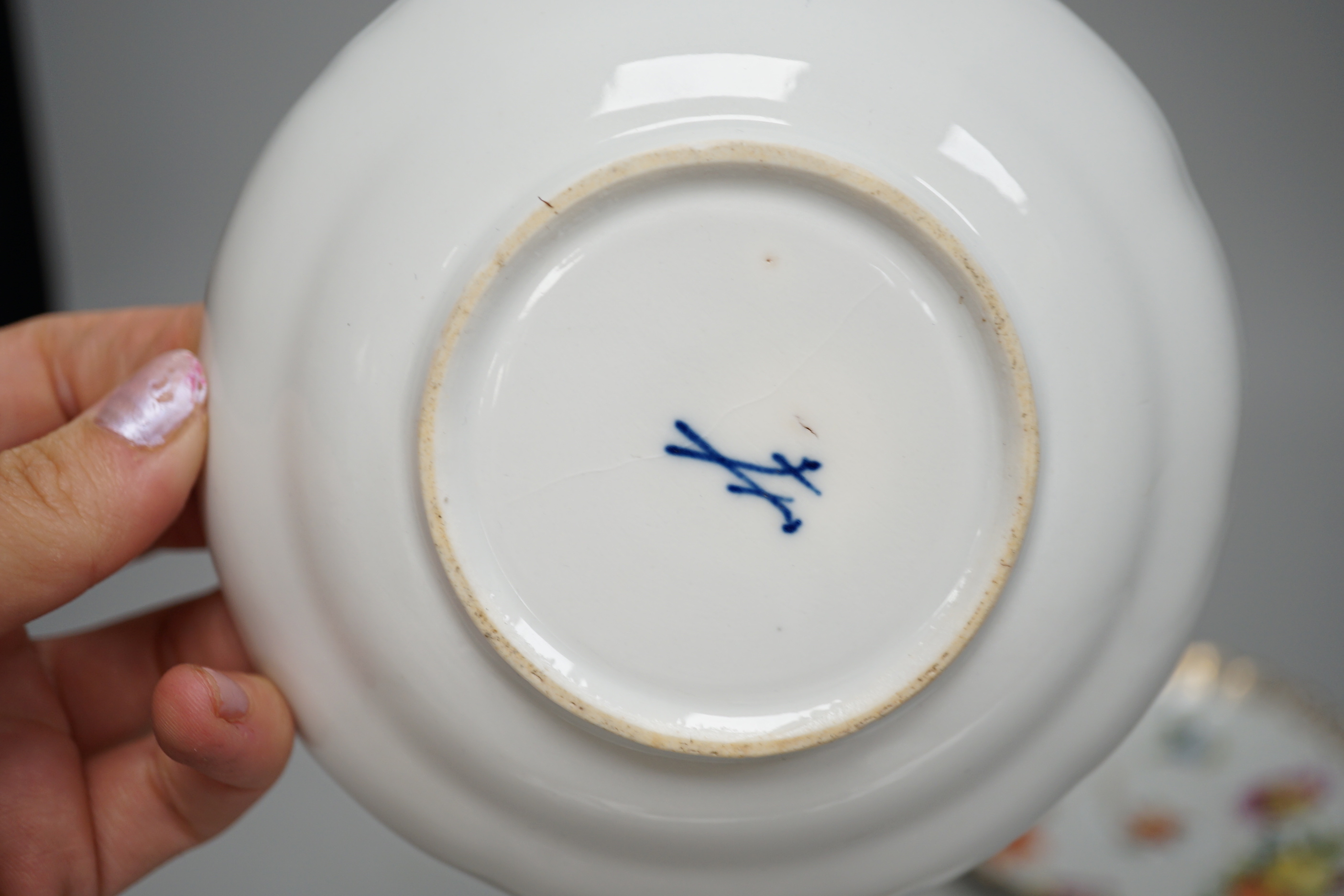 A Meissen style porcelain teacup and saucer together with a Dresden saucer and teacup and saucer
